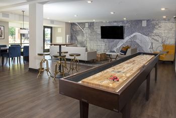 Large clubroom with easy pool access, shuffleboard, entertaining bar, and a Flat screen TV.